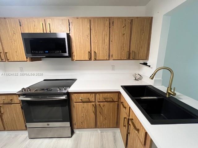 6735 West 26th Drive, Unit 125 Hialeah, FL 33016 - Photo 7 of 9 a kitchen with a sink and a stove top oven
