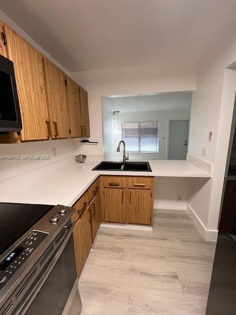 6735 West 26th Drive, Unit 125 Hialeah, FL 33016 - Photo 8 of 9 a kitchen with a sink and a stove top oven