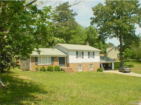5211 Knollwood Road Raleigh, NC 27609 - Photo 1 of 1 a front view of a house with a yard table and chairs
