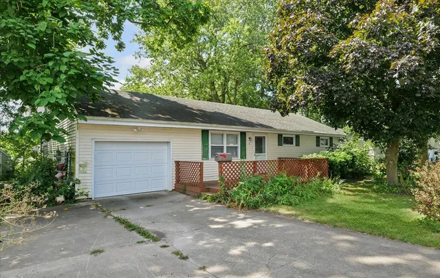 a front view of house with yard and trees