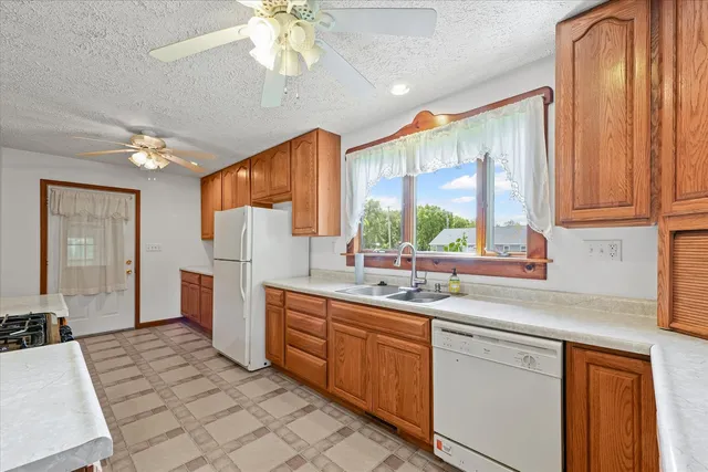 a kitchen with a sink stove and cabinets