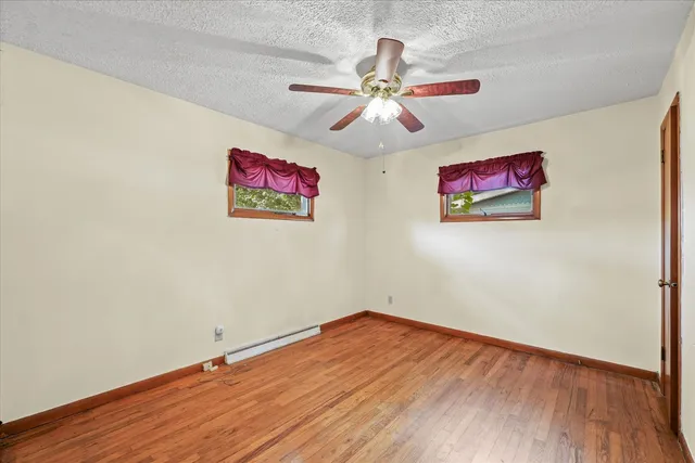 a view of a room with wooden floor and fan view