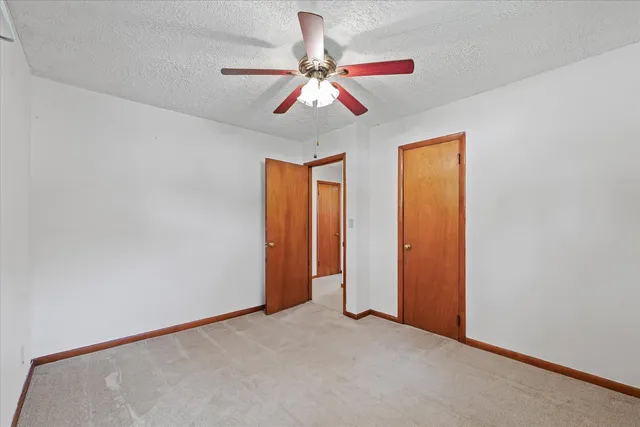 a view of room with window and ceiling fan