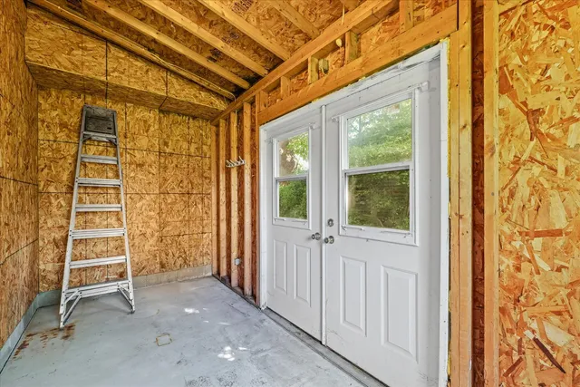 a view of wooden door and a window