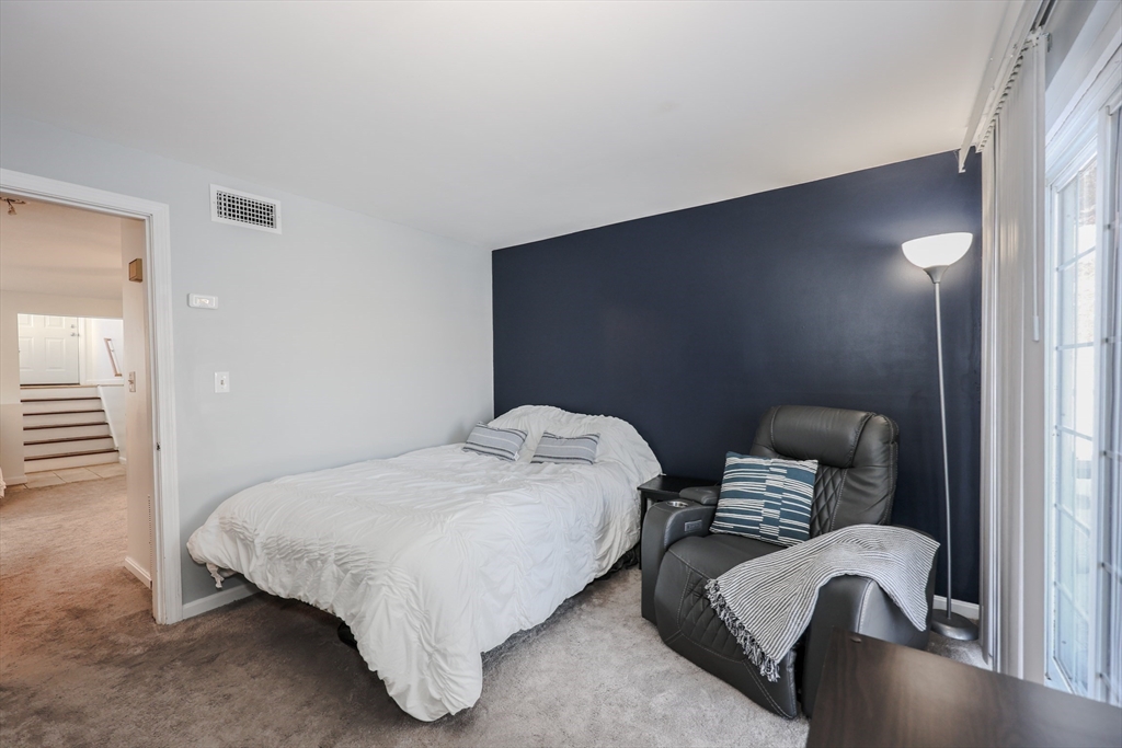 5 East Ridge Road, Unit A Merrimack, NH 03054 - Photo 11 of 19 a bedroom with bed and a chair