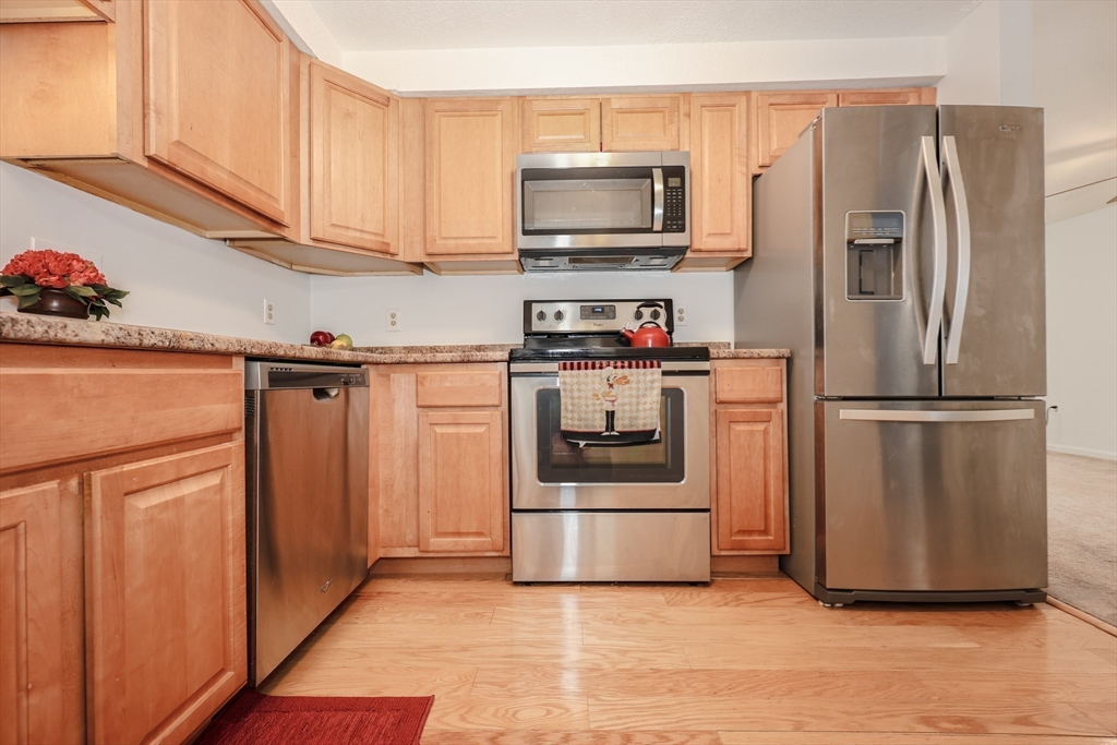 5 East Ridge Road, Unit A Merrimack, NH 03054 - Photo 14 of 19 a kitchen with appliances a microwave and cabinets