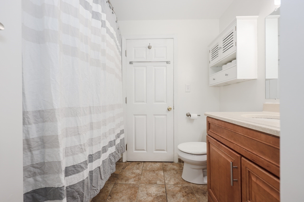 5 East Ridge Road, Unit A Merrimack, NH 03054 - Photo 15 of 19 a bathroom with a granite countertop sink a toilet and shower