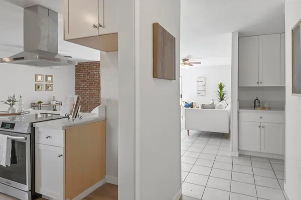 a kitchen with a sink a stove and cabinets