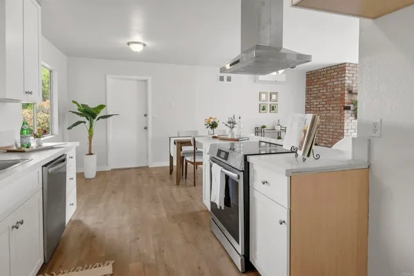 a kitchen with a sink a counter and cabinets