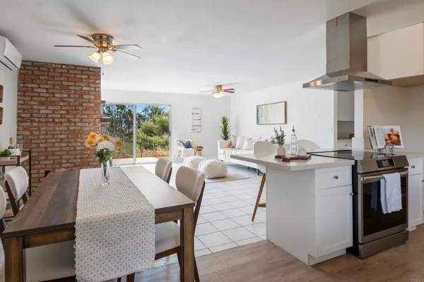 a kitchen with a sink a refrigerator and white cabinets