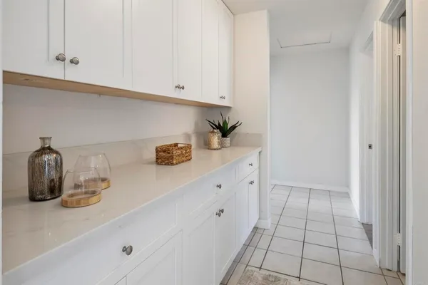 a hallway with cabinets and a window