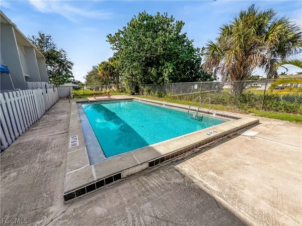 a view of swimming pool with a lounge chairs