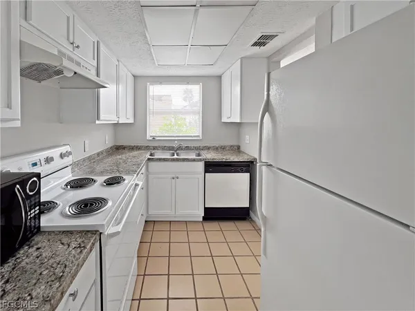 a kitchen with a stove a sink and a refrigerator