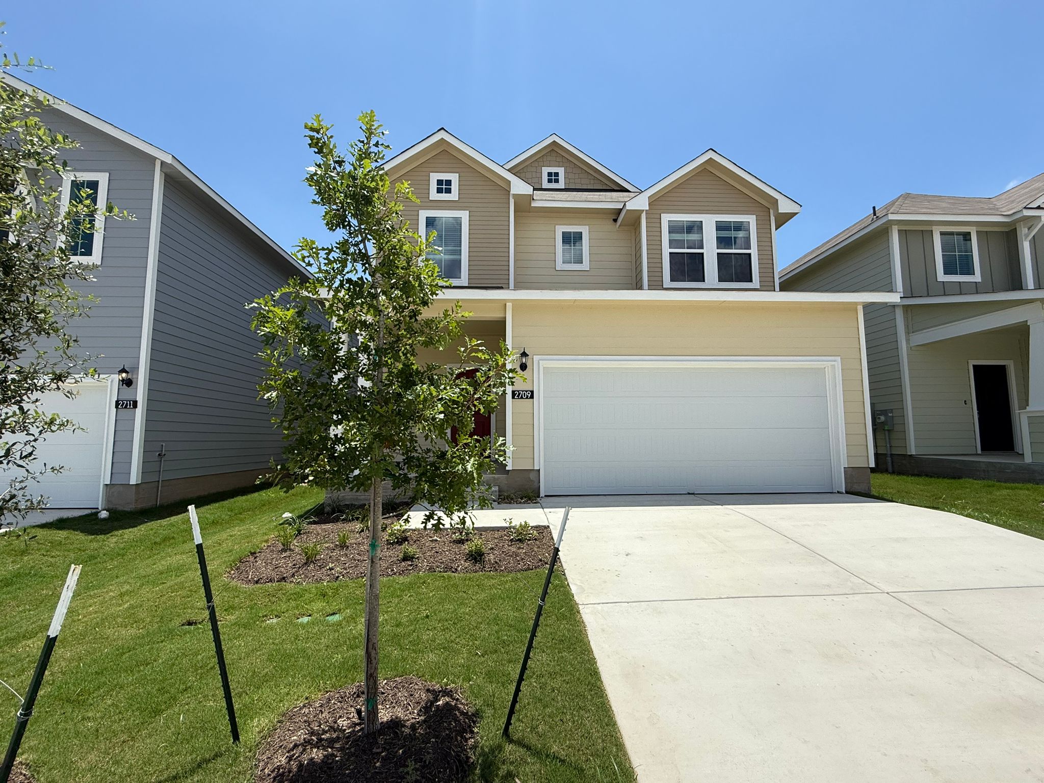 2709 Totley Road Manor, TX 78653 - Photo 2 of 40 a front view of a house with a garden