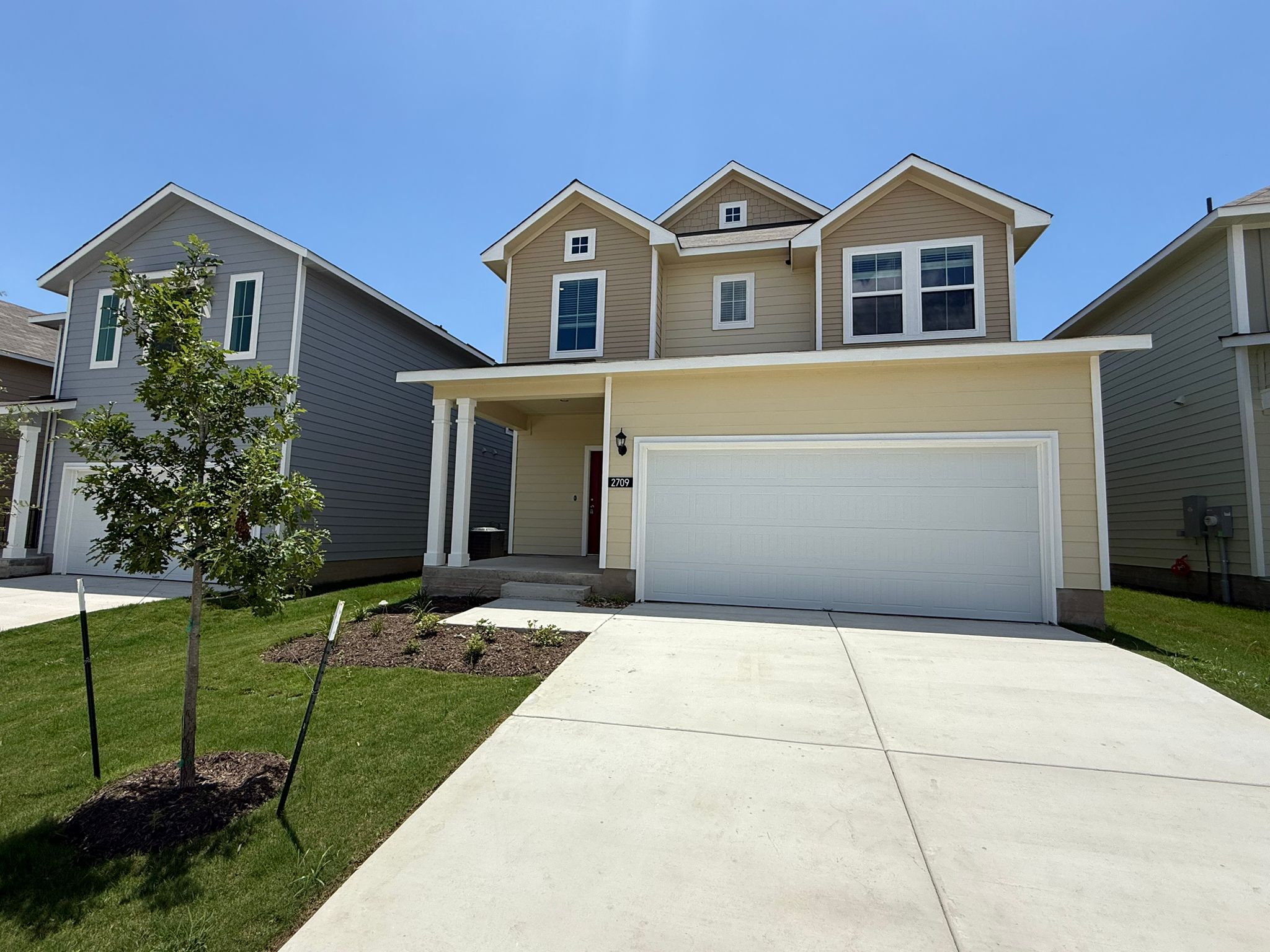 2709 Totley Road Manor, TX 78653 - Photo 3 of 40 a front view of a house with a yard and garage