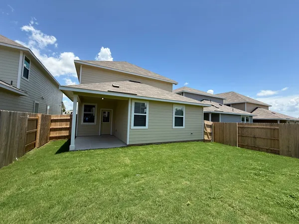 a view of a house with a yard and a garage