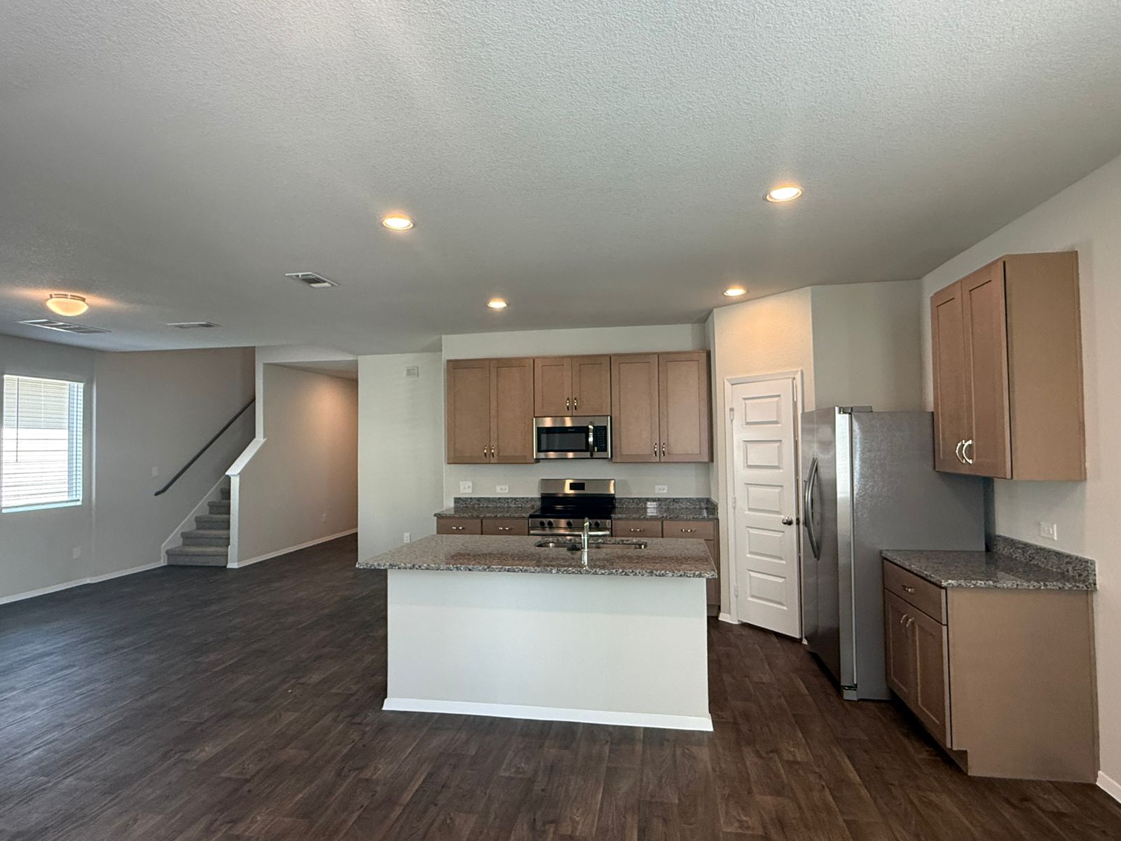 2709 Totley Road Manor, TX 78653 - Photo 9 of 40 a kitchen with stainless steel appliances a refrigerator and wooden floor