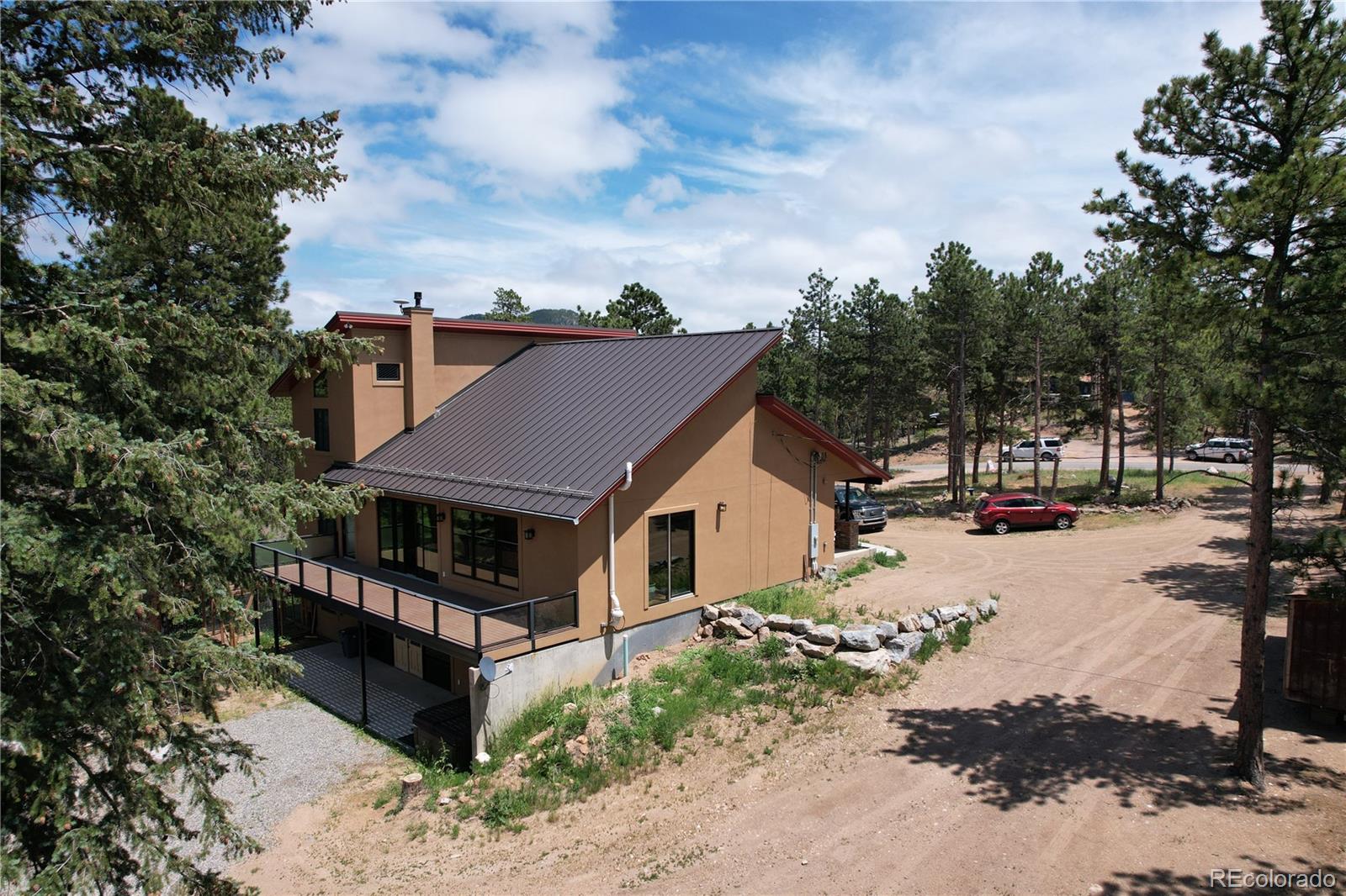 11668 Ranch Elsie Road Golden, CO 80403 - Photo 3 of 40 a view of a house with wooden fence