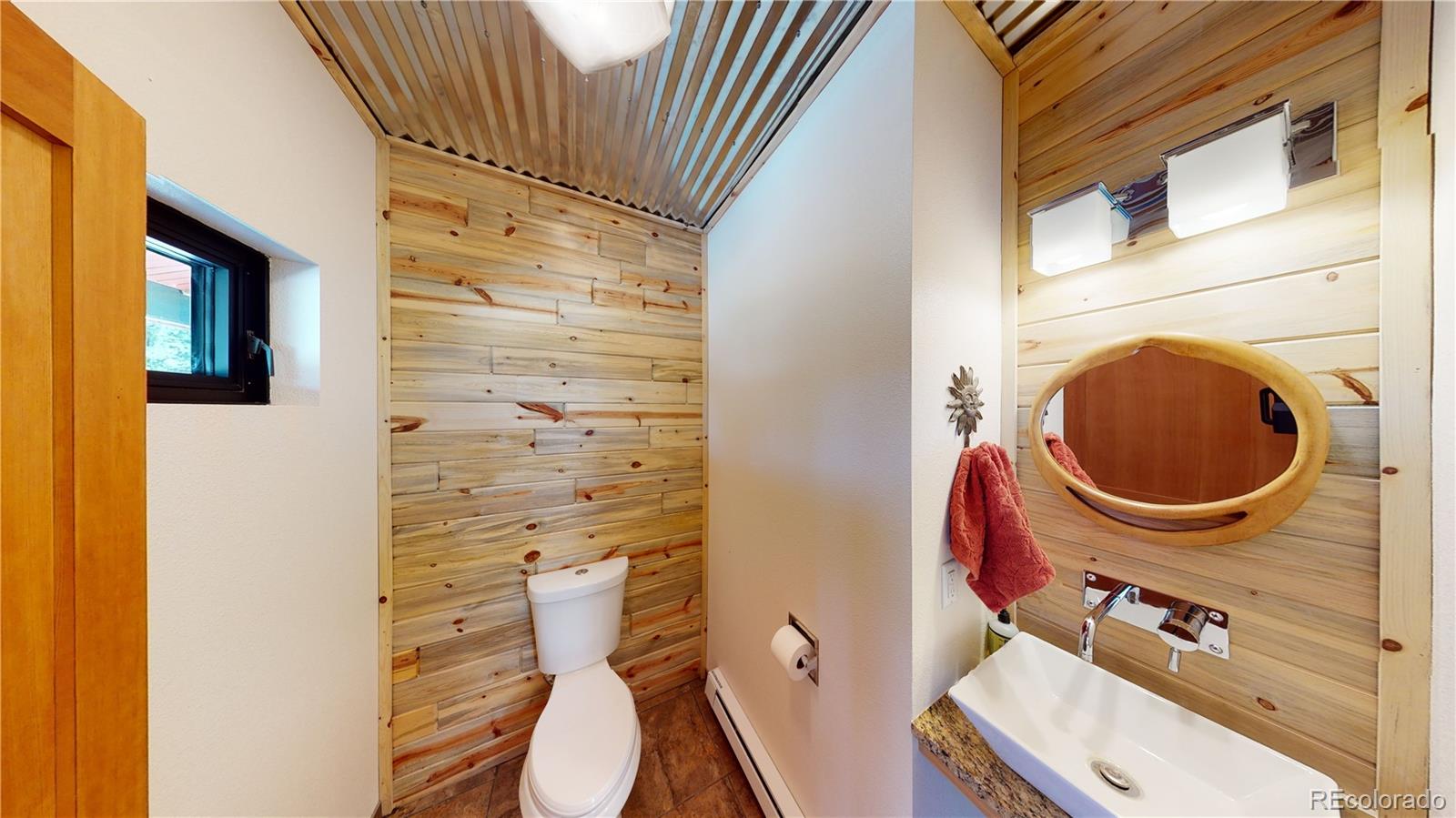 11668 Ranch Elsie Road Golden, CO 80403 - Photo 8 of 40 a bathroom with a sink a toilet and shower