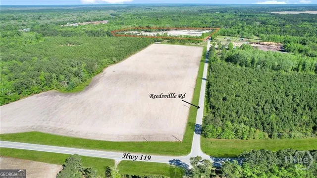 a view of a garden with a building in the background