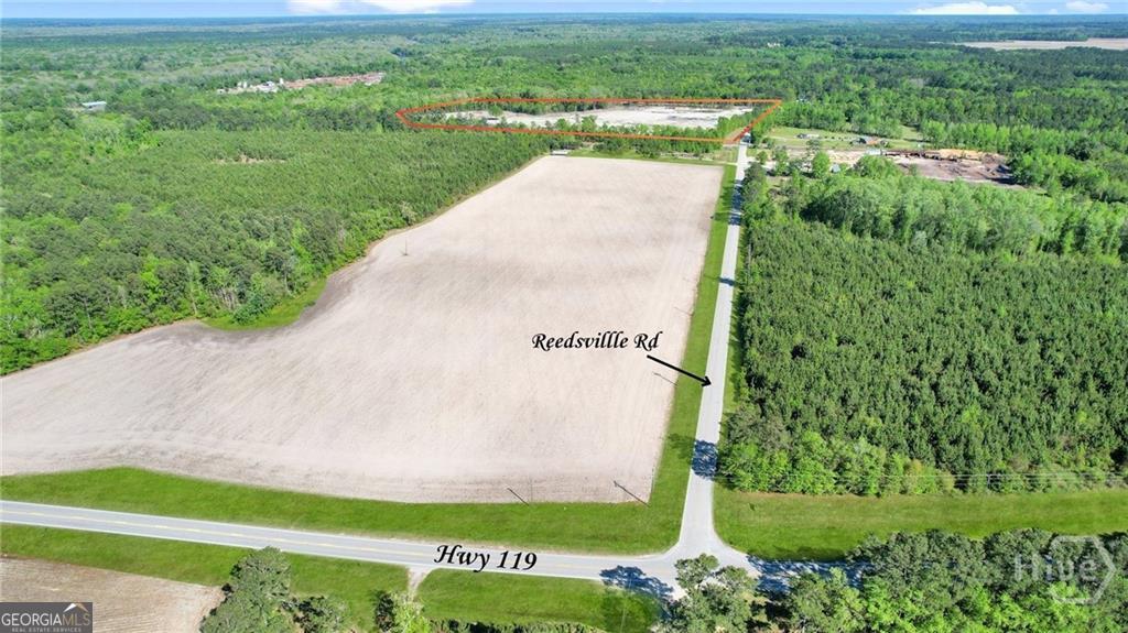1382 Reedsville Road Clyo, GA 31303 - Photo 8 of 10 a view of a garden with a building in the background