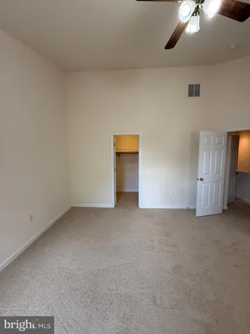 an empty room with a empty space and a ceiling fan