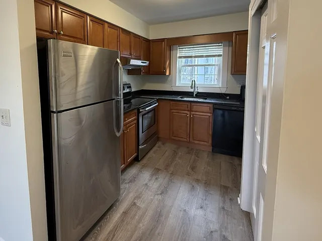 a kitchen with a refrigerator and a sink