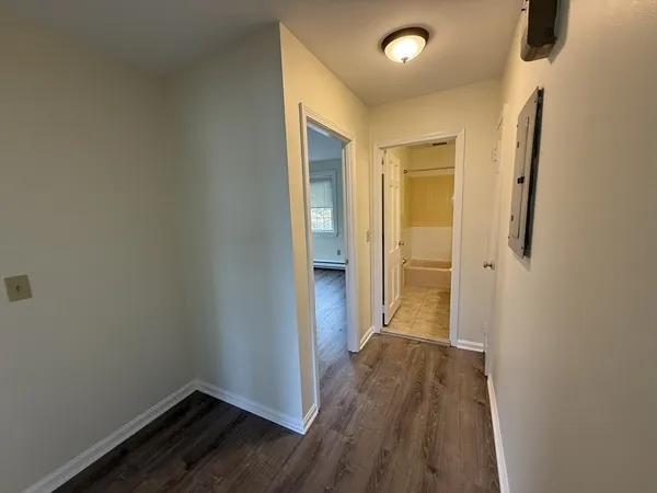 a view of hallway with wooden floor