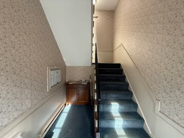 a view of entryway and hall with wooden floor