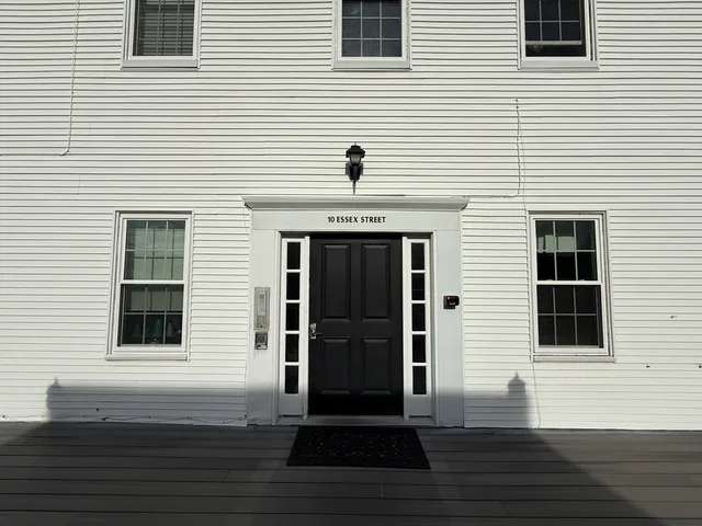 a view of a house with wooden deck