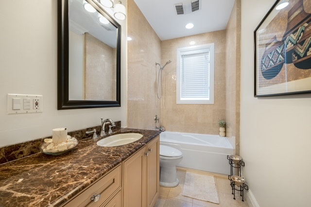 115 Dickens Road Northfield, IL 60093 - Photo 6 of 24 a bathroom with a granite countertop sink and a mirror