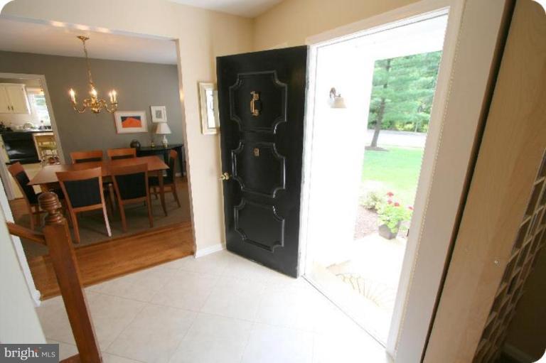 10915 Hunt Club Road Reston, VA 20190 - Photo 2 of 27 a view of a hallway and dining room with wooden floor