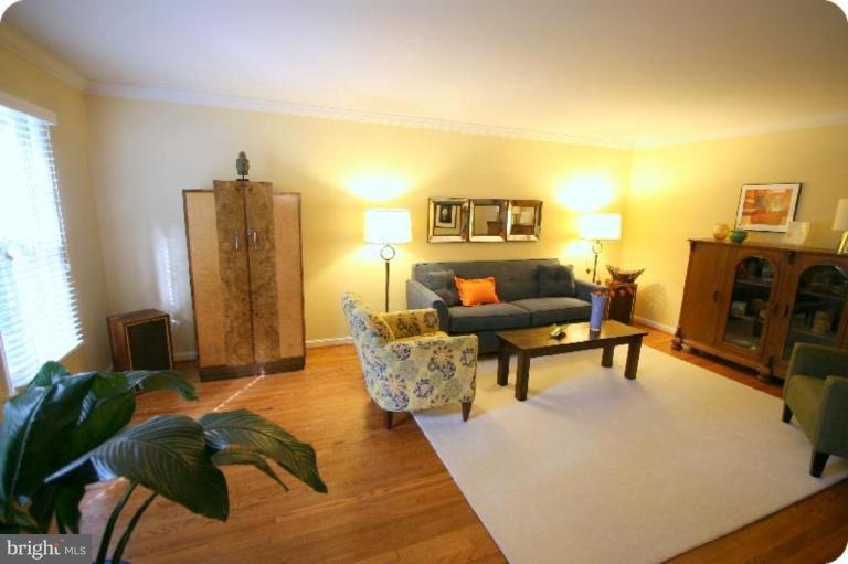 10915 Hunt Club Road Reston, VA 20190 - Photo 4 of 27 a living room with furniture and a flat screen tv