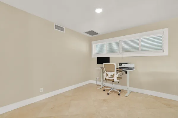 an empty room with a table and a chair