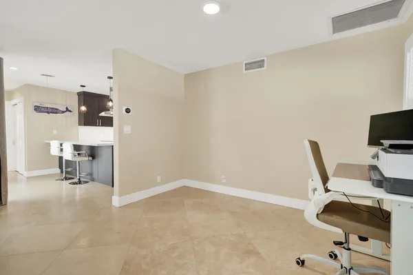 a living room with furniture a window and chairs