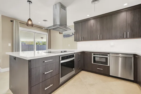 a kitchen with stainless steel appliances white cabinets and a refrigerator