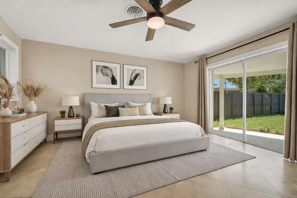 a bedroom with a large bed and a chandelier