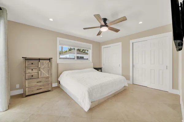 a bed room with a bed and a large window