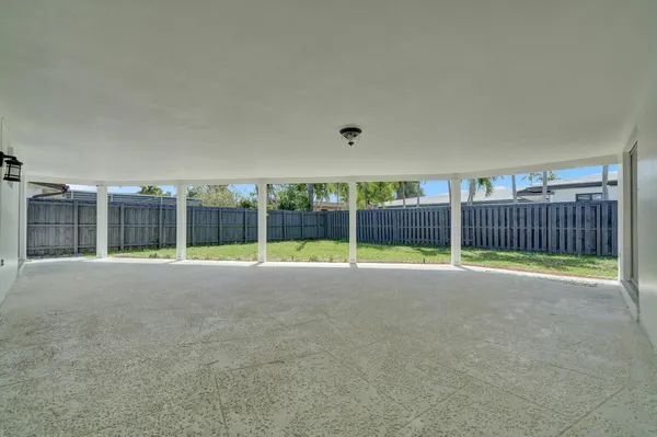 a view of an house with backyard and porch