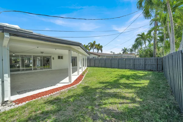 a view of a backyard with wooden fence