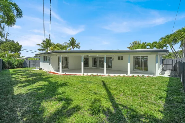 a view of a house with backyard sitting area and garden