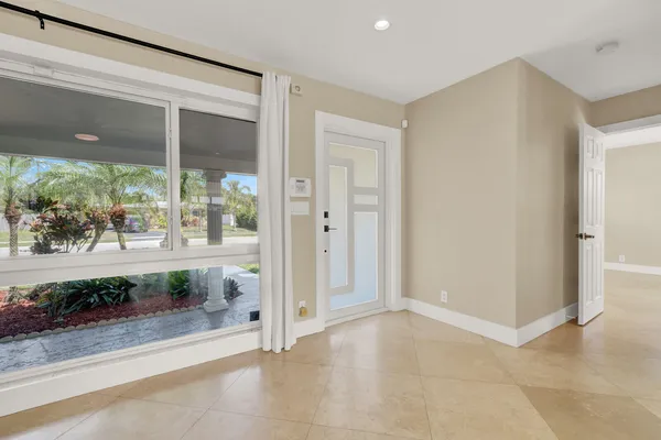 a view of a big room with a floor to ceiling window and outdoor view