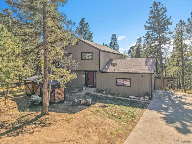 a view of a house with a yard and sitting area