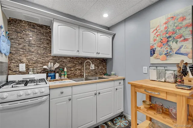 a bedroom with large trees and a wooden deck