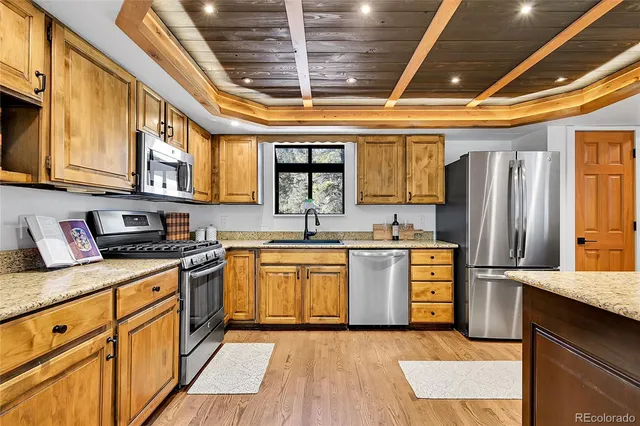 a dining room with furniture a chandelier and wooden floor