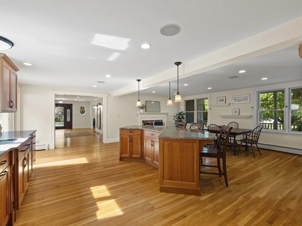 22 Bryant Road Lexington, MA 02420 - Photo 11 of 40 a dining hall with stainless steel appliances granite countertop a table chairs and a living room view