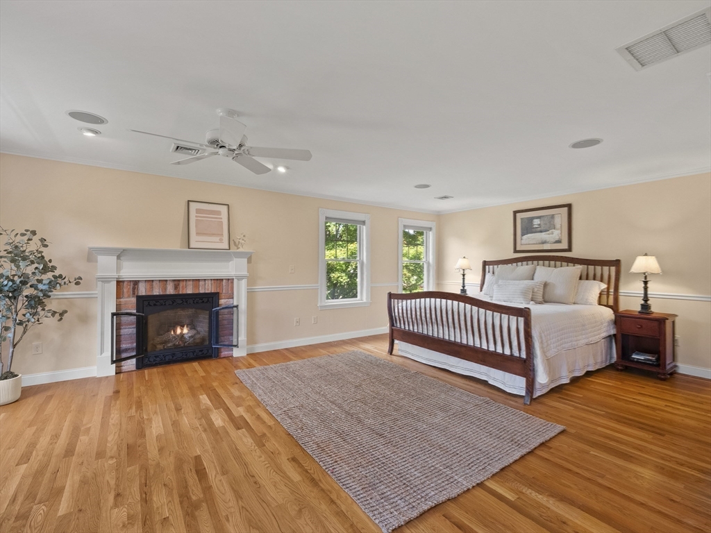 22 Bryant Road Lexington, MA 02420 - Photo 17 of 40 a spacious bedroom with a bed and a fireplace