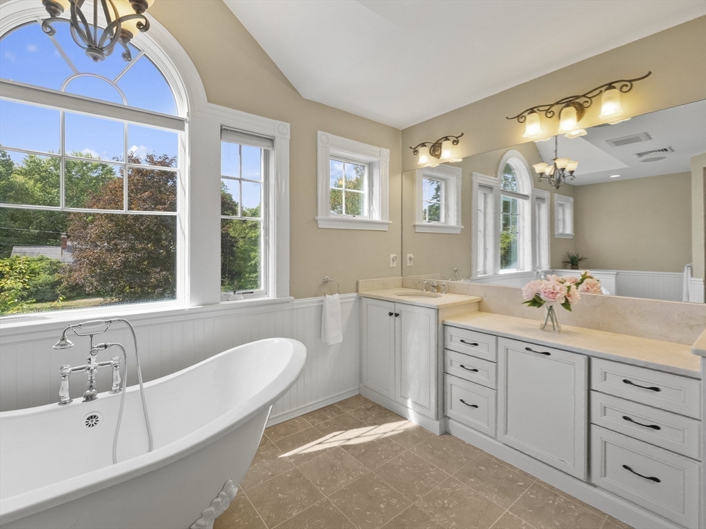 22 Bryant Road Lexington, MA 02420 - Photo 20 of 40 a spacious bathroom with a tub double sink window and mirror