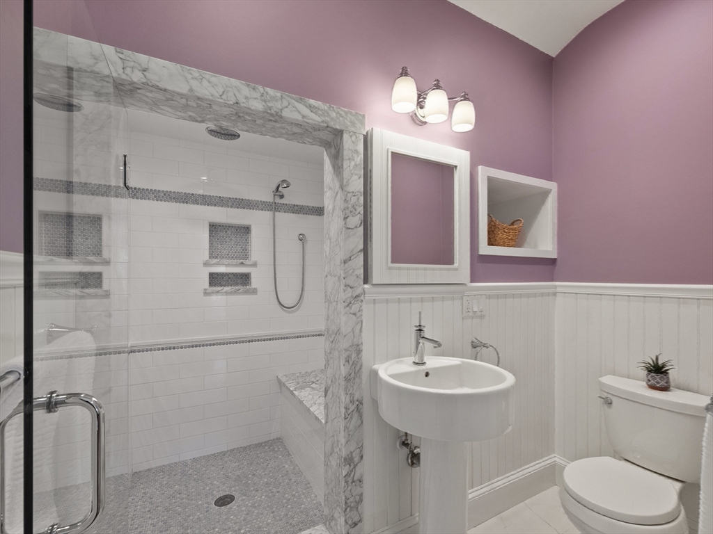 22 Bryant Road Lexington, MA 02420 - Photo 27 of 40 a bathroom with a sink a toilet a mirror and vanity