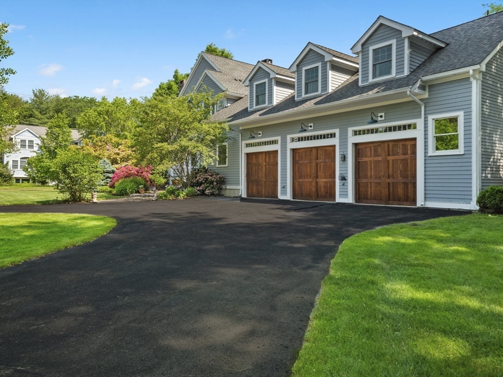 22 Bryant Road Lexington, MA 02420 - Photo 3 of 40 a front view of a house with a yard and trees